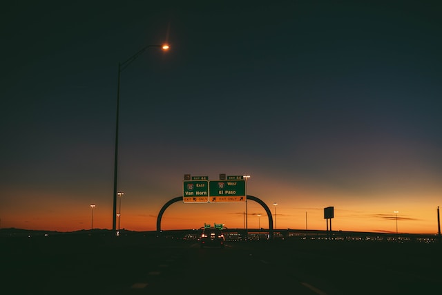 Dusk photo after sunset in El Paso, Texas, on a highway showing road signs